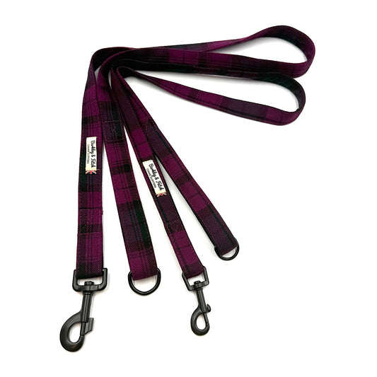 Plaid dog leash with black metal clips on a white background