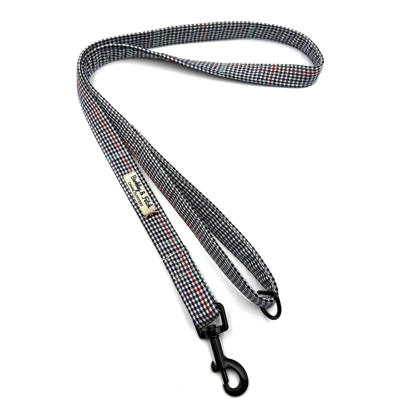 Checkered dog leash with a clip on a white background