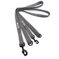 Houndstooth patterned dog leash with metal clip on a white background