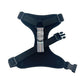 Black dog harness with a checkered strap on a white background
