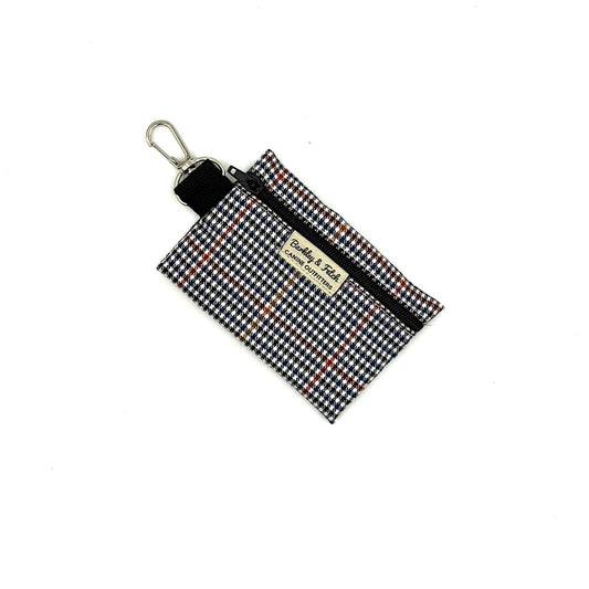 Houndstooth patterned pouch with keychain clip on a white background