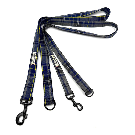 Plaid dog leash with black metal clips on a white background