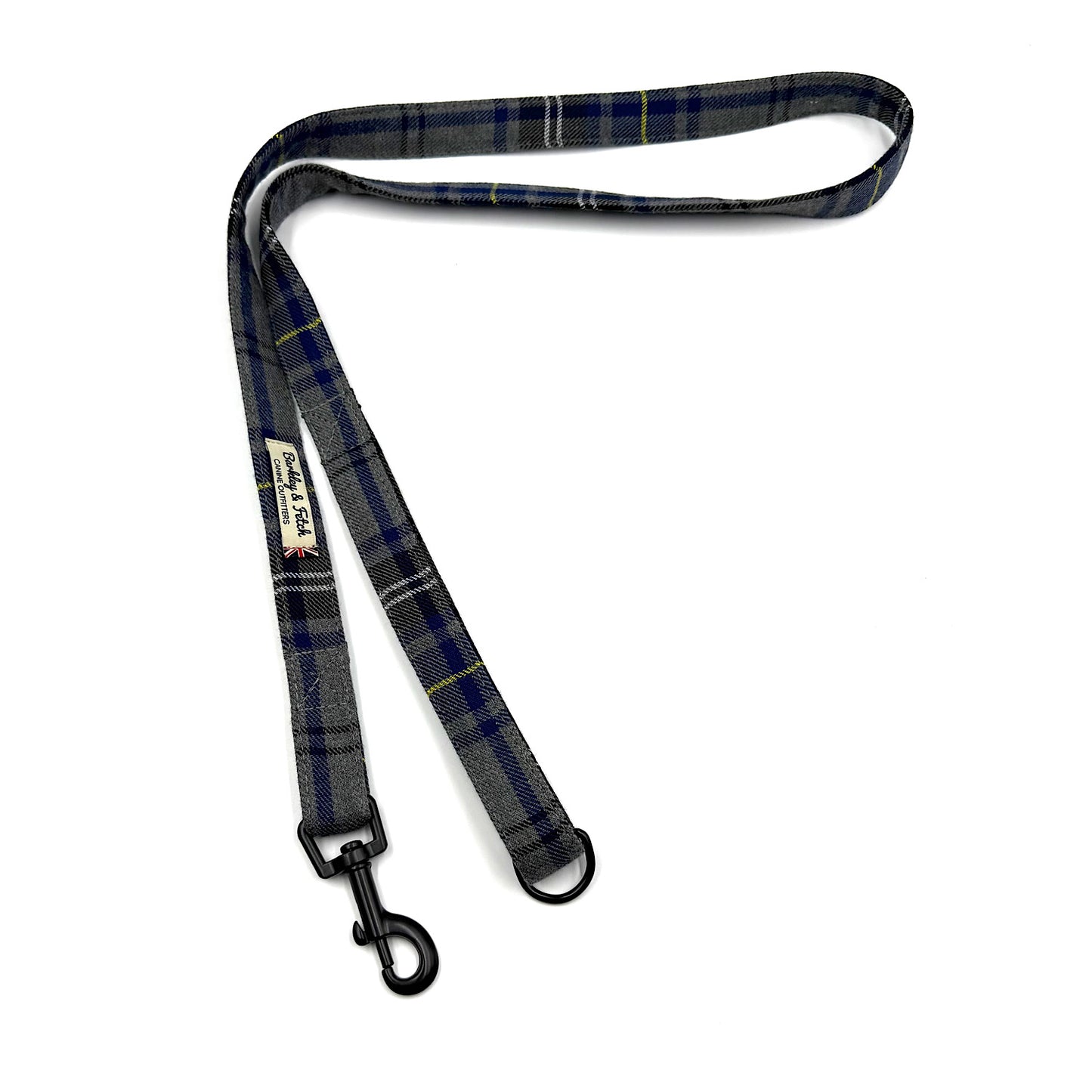 Plaid dog leash with black clip on a white background