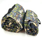 Two rolled-up patterned blankets on a white background