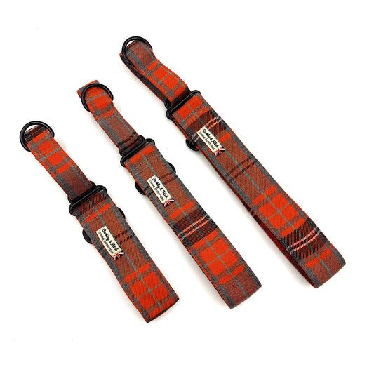 Three plaid dog collars on a white background