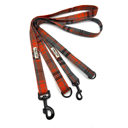 Plaid dog leash with black clip on a white background