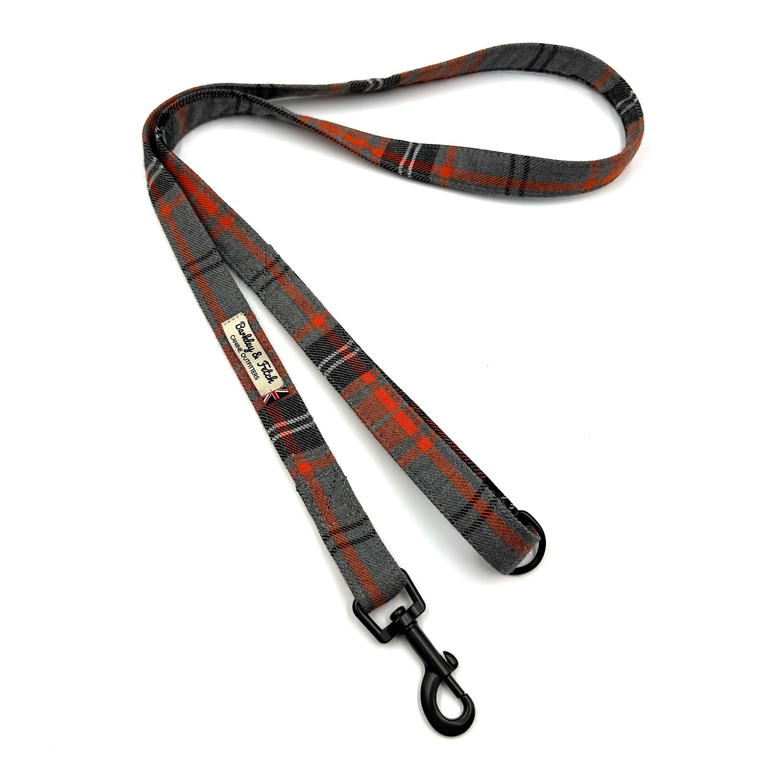 Plaid dog leash with a clip on a white background