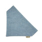 Blue textured fabric triangle with a brand label on a white background