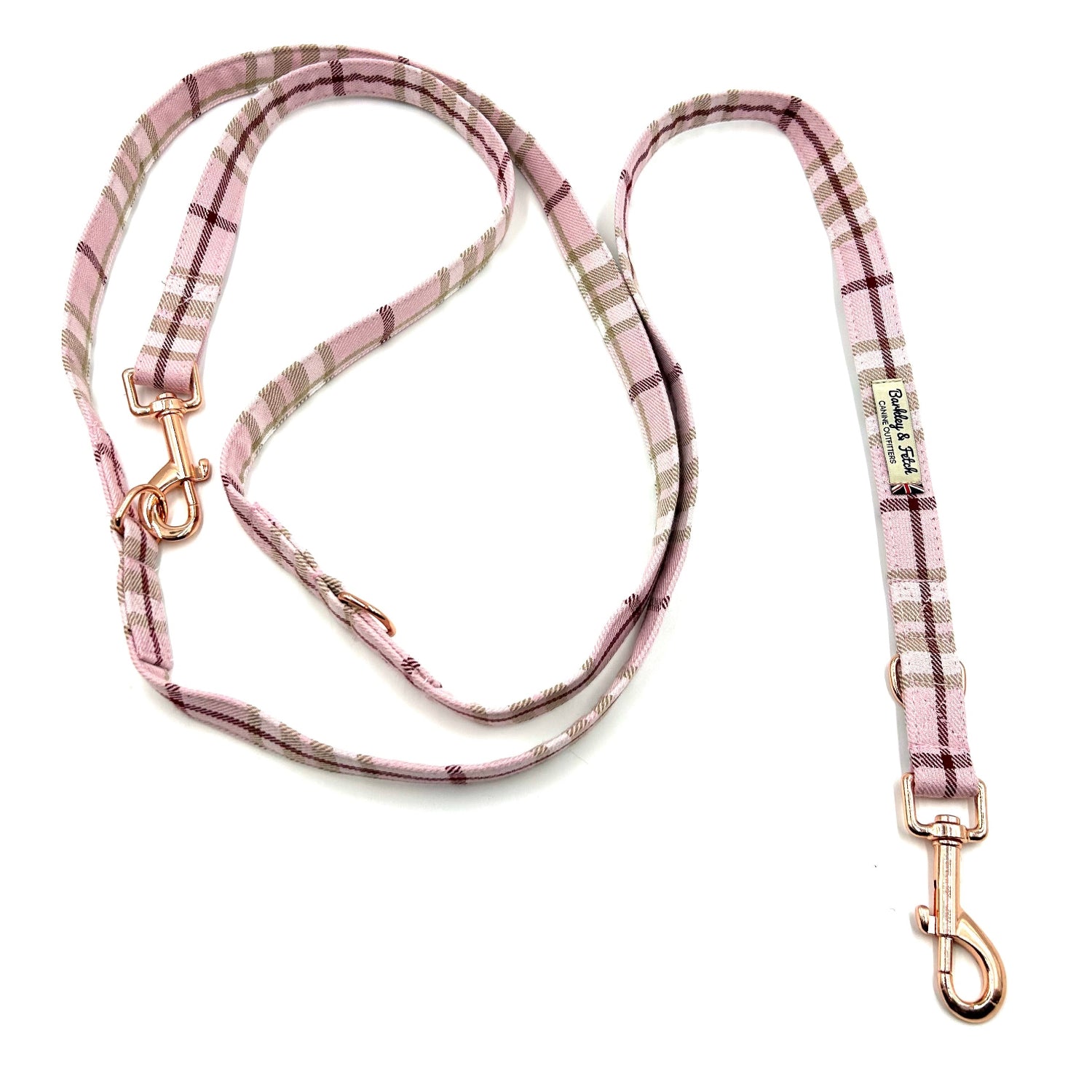 Pink plaid dog leash with gold hardware on a white background