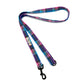Colorful plaid dog leash with a black clip on a white background