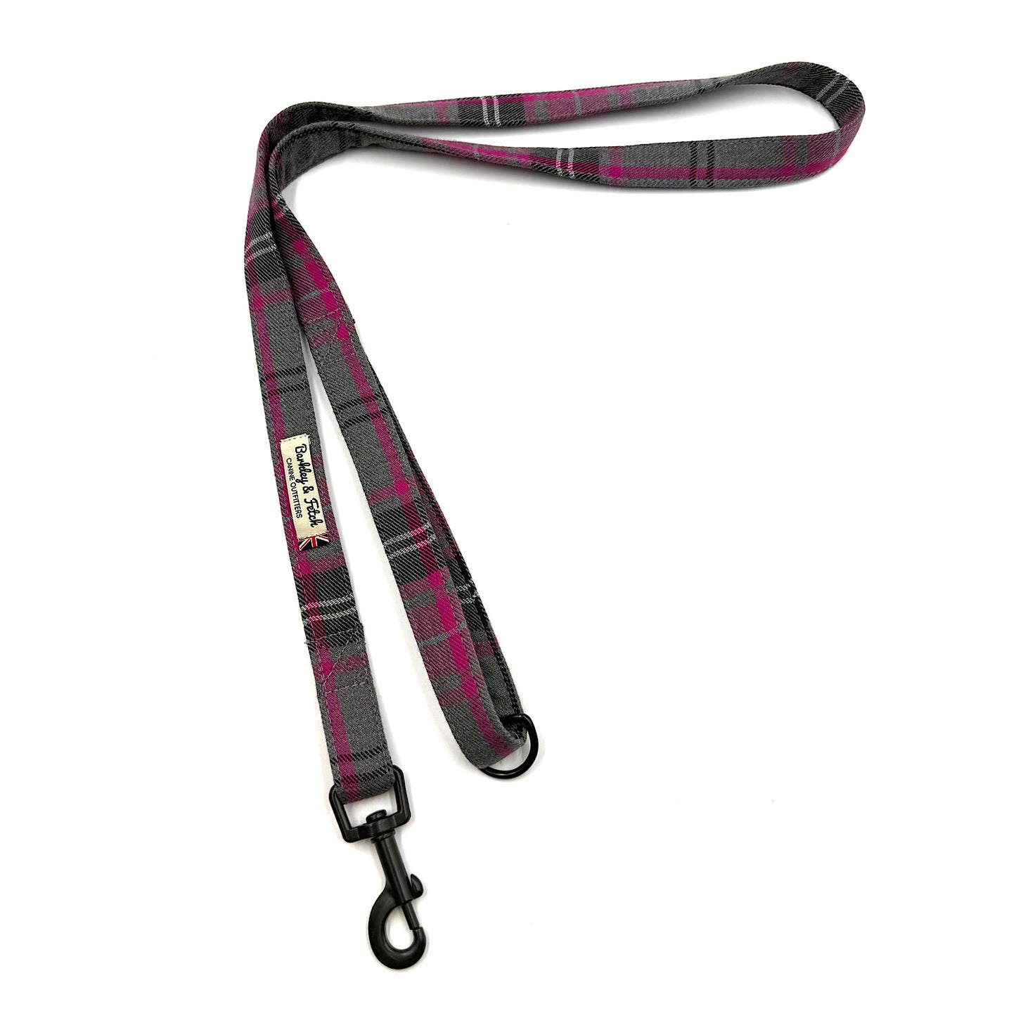 Plaid dog leash with a black clip on a white background
