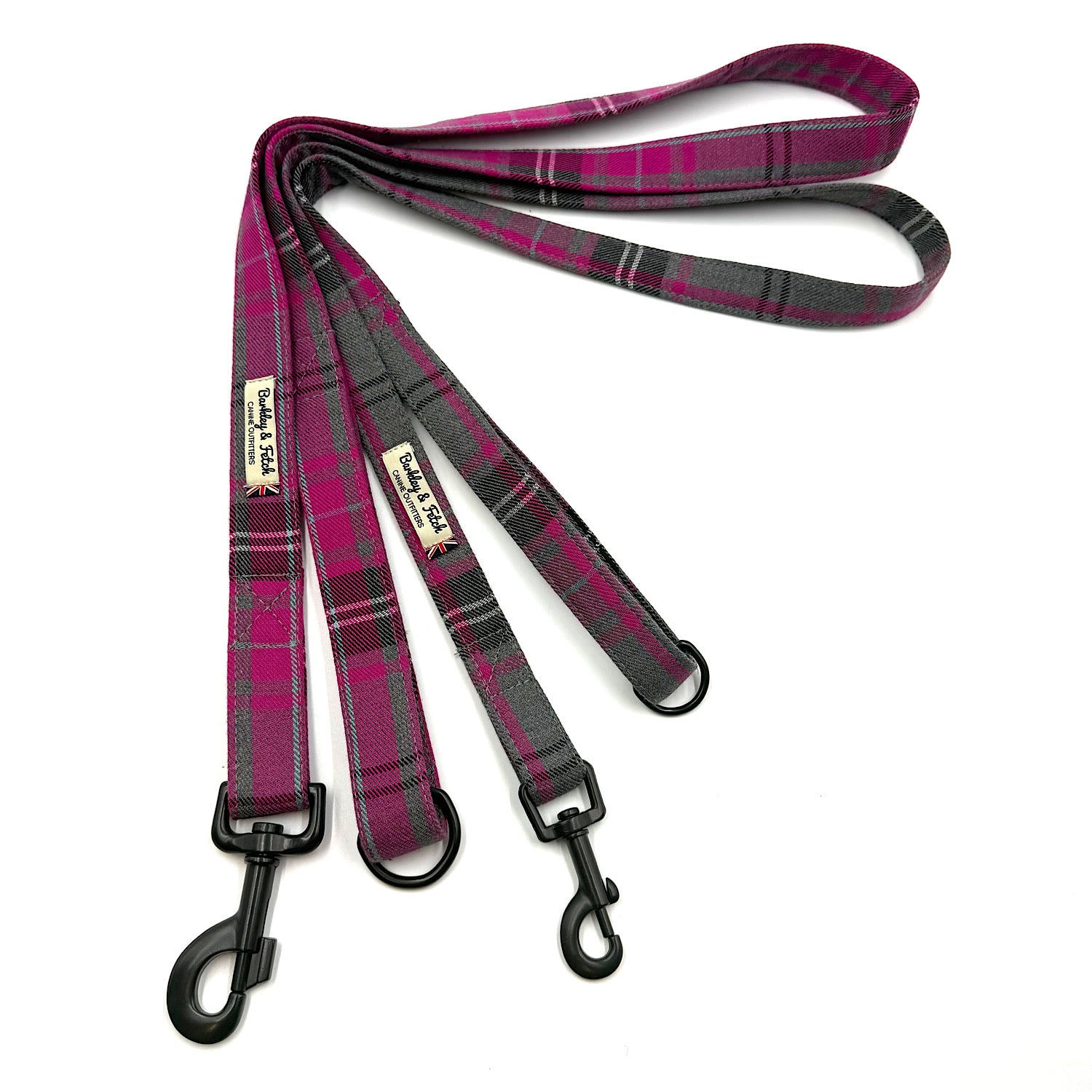 Plaid dog leash with black clip on a white background