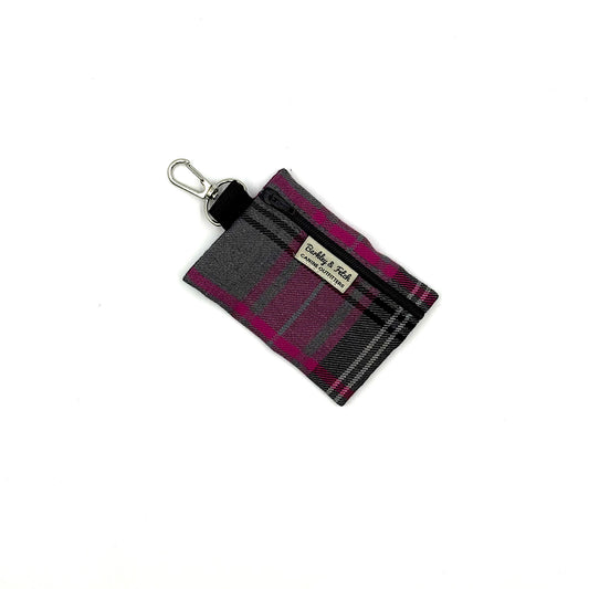 Plaid keychain pouch with a visible brand label on a white background
