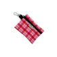 Pink and red plaid pouch with a black strap on a white background