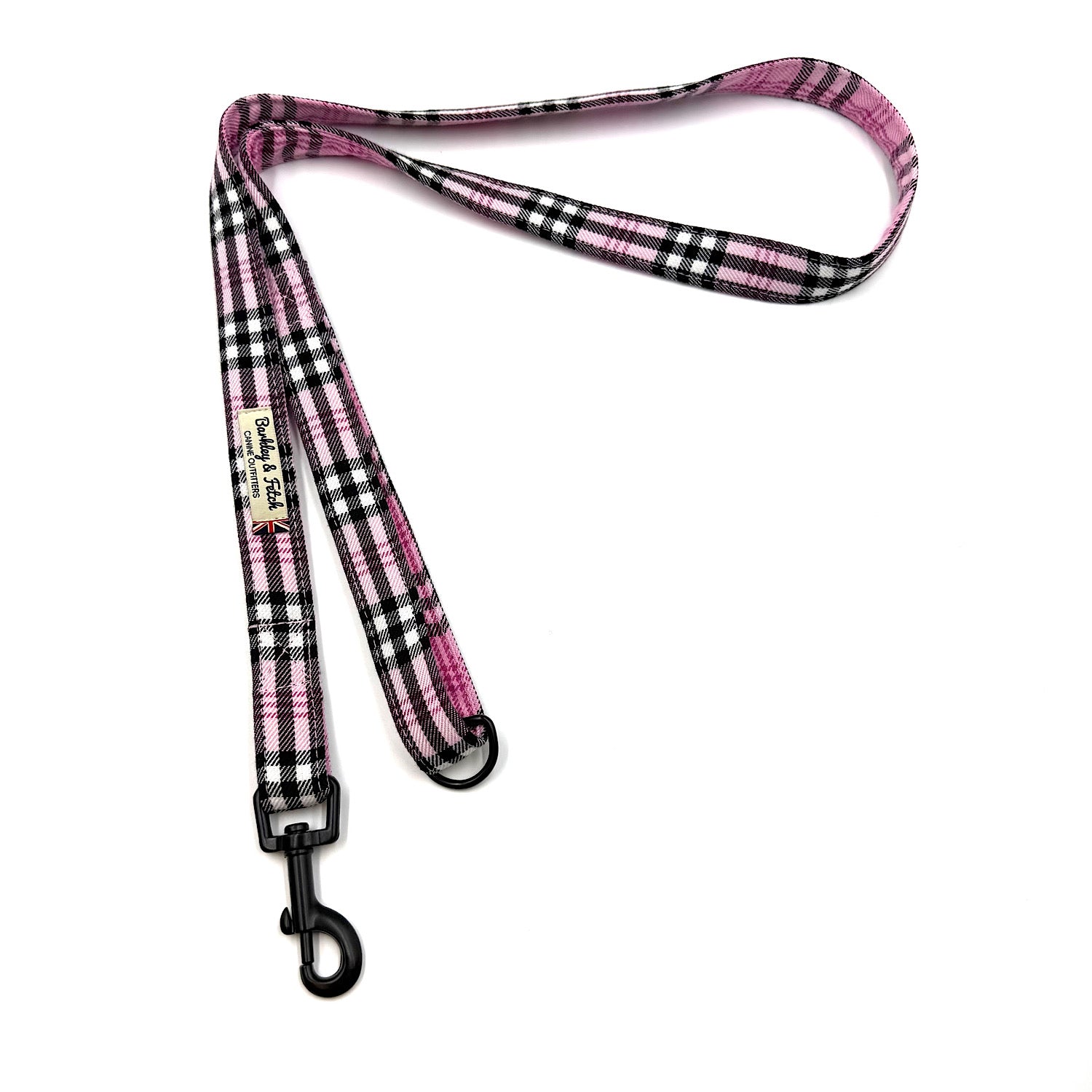 Pink and black plaid dog leash on a white background