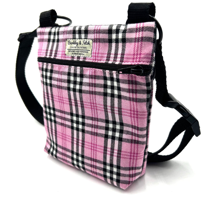Pink plaid crossbody bag with black straps on a white background