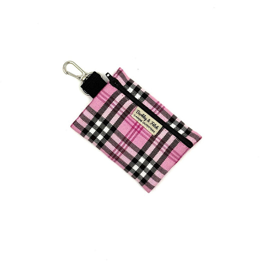 Pink and black plaid pouch with a key ring on a white background