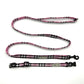 Pink and black checkered dog collar and leash set on a white background
