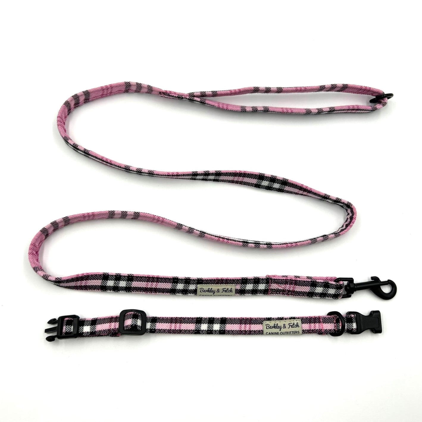 Pink and black checkered dog collar and leash set on a white background