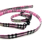 Pink and black plaid dog collar and leash set on a white background