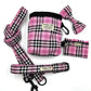 Pink plaid pet accessory set including a bag, leash, and bow tie on a white background.