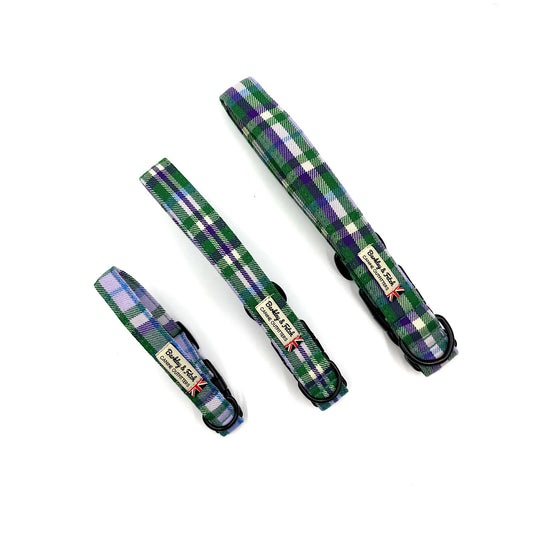 Set of plaid dog collars in green, purple, and white on a white background