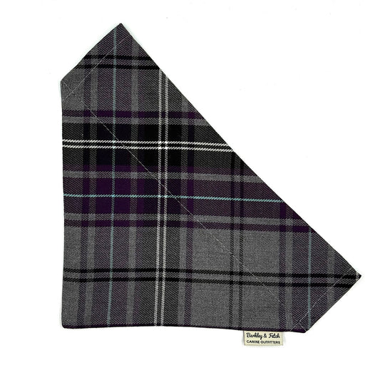 Plaid fabric triangle with visible brand label on a white background