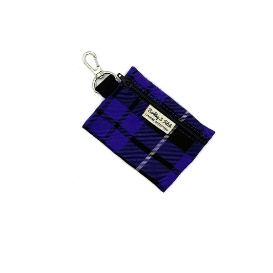 Blue plaid fabric keychain pouch with a visible brand label on a white background