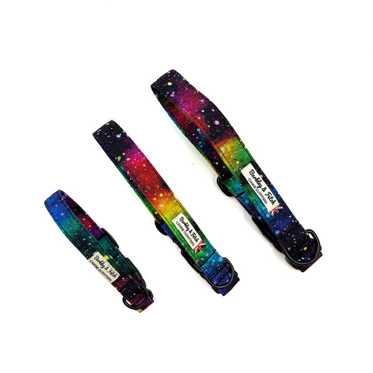 Three colorful dog collars with a space-themed design on a white background.