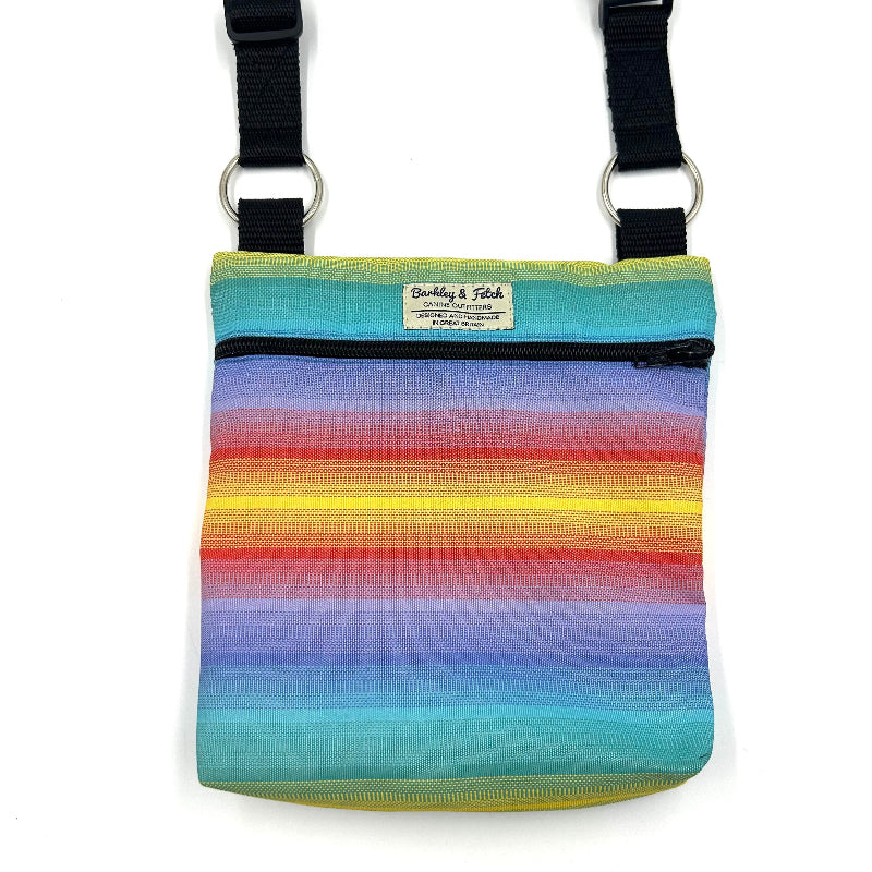 Colorful striped bag with black straps on a white background