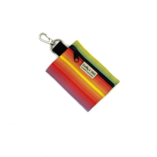 Colorful striped keychain pouch with a brand logo on a white background