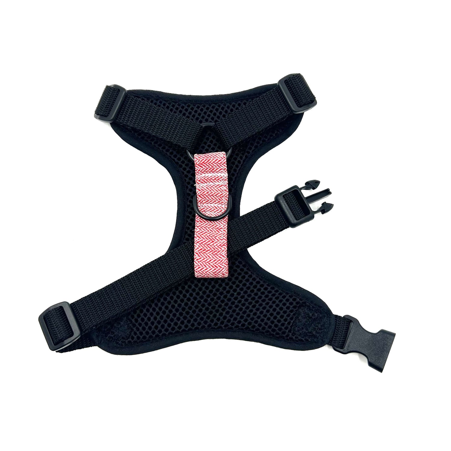 Black dog harness with a pink strap on a white background