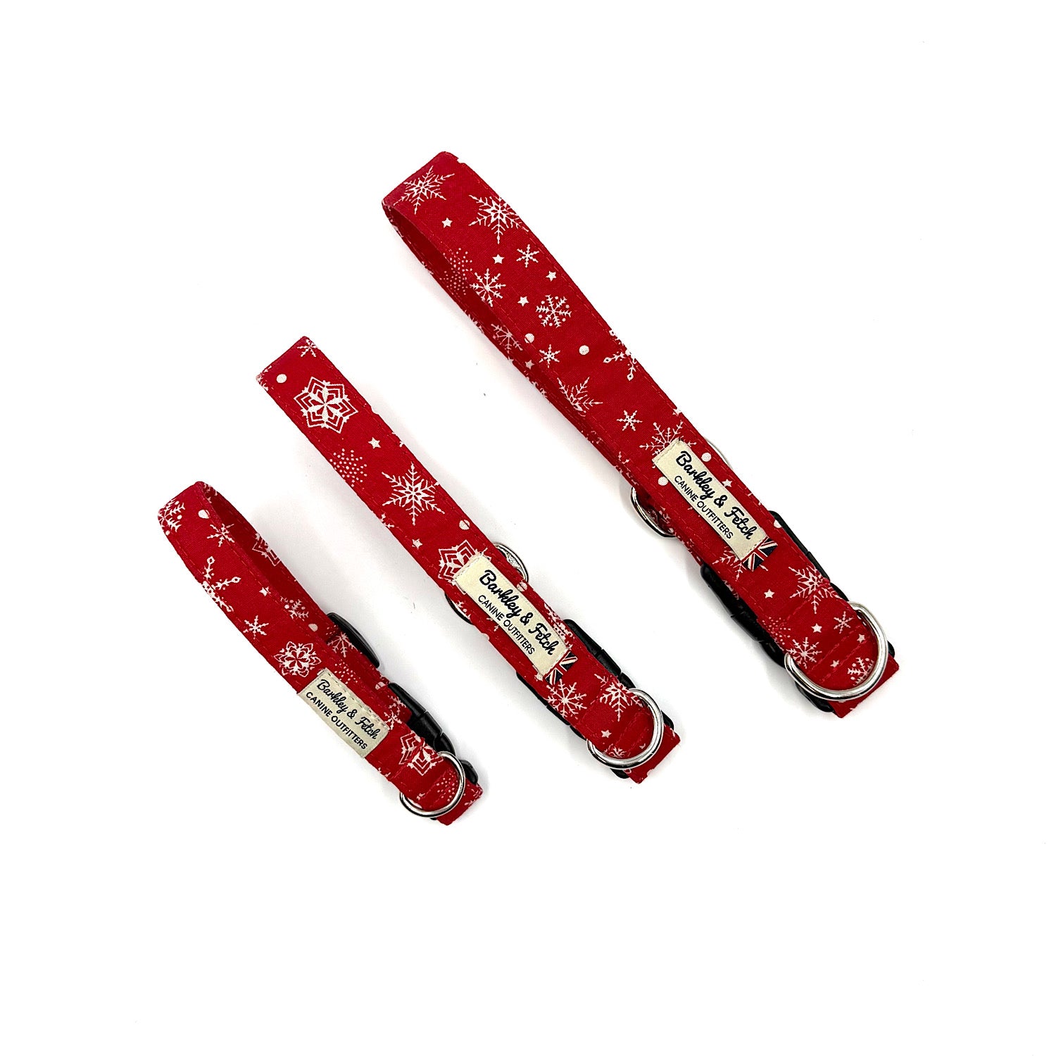three red christmas dog collars with white snowflake pattern on a white background handmade by barkley and fetch uk