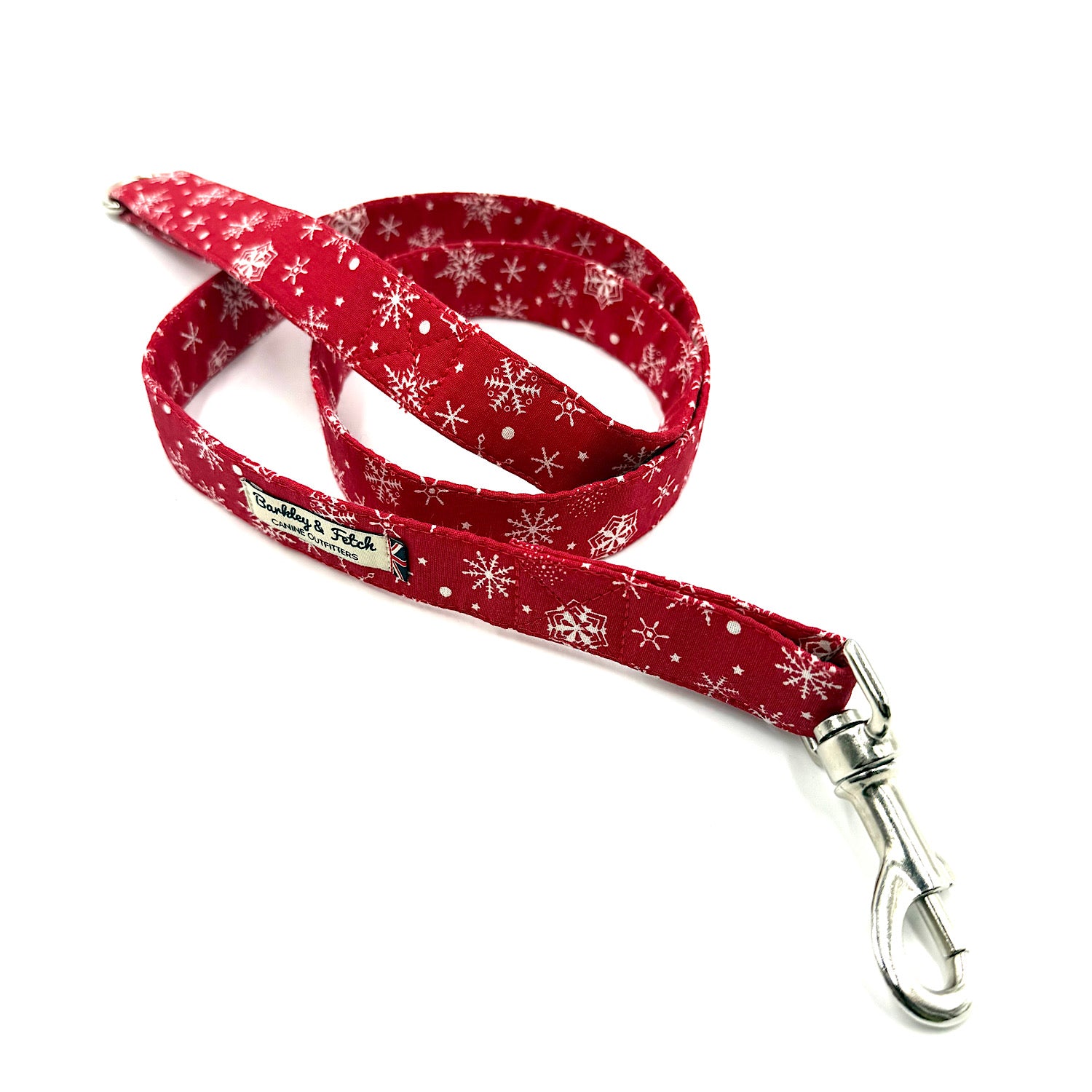 Red dog leash with white snowflake pattern on a white background handmade by barkley and fetch uk