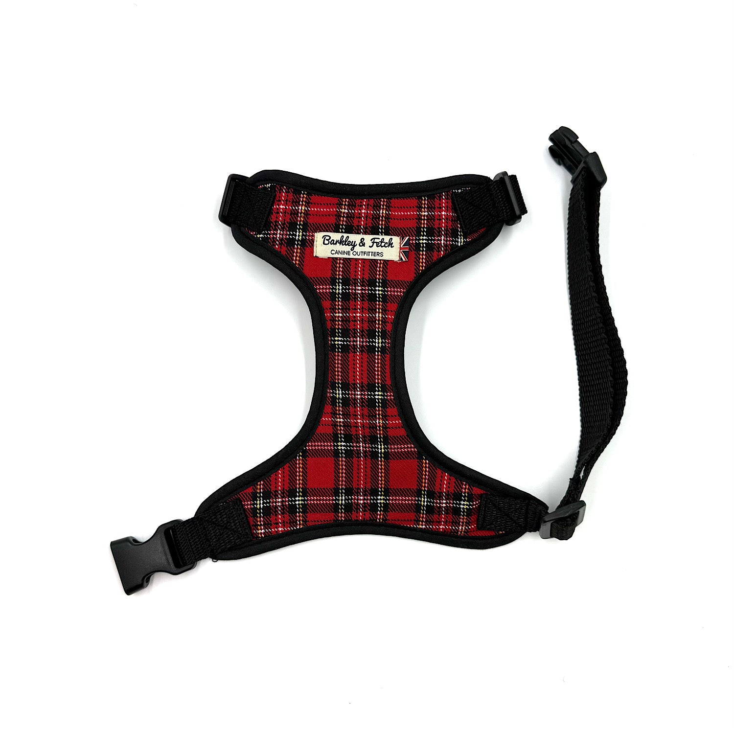 Red plaid dog harness with black straps on a white background Classic red tartan dog harness, handmade in the UK. Adjustable for the perfect fit with matching collar and lead available.