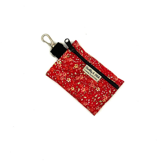 Red floral keychain pouch with a black zipper on a white background