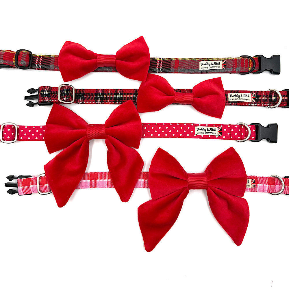 Set of dog collars with red bow ties on a white background