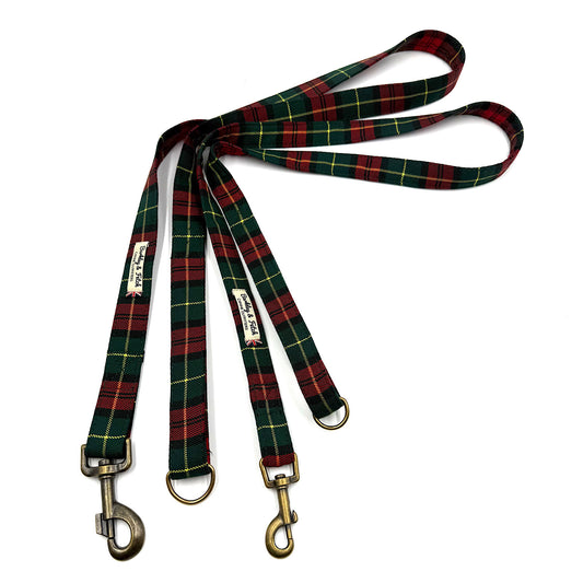Plaid dog leash with brass hooks on a white background