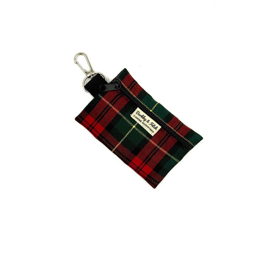 Plaid keychain pouch with visible brand name on a white background