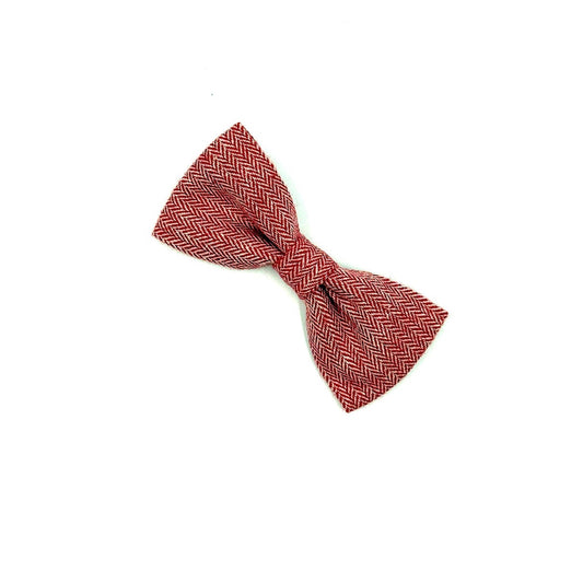 Red bow tie with a subtle pattern on a white background