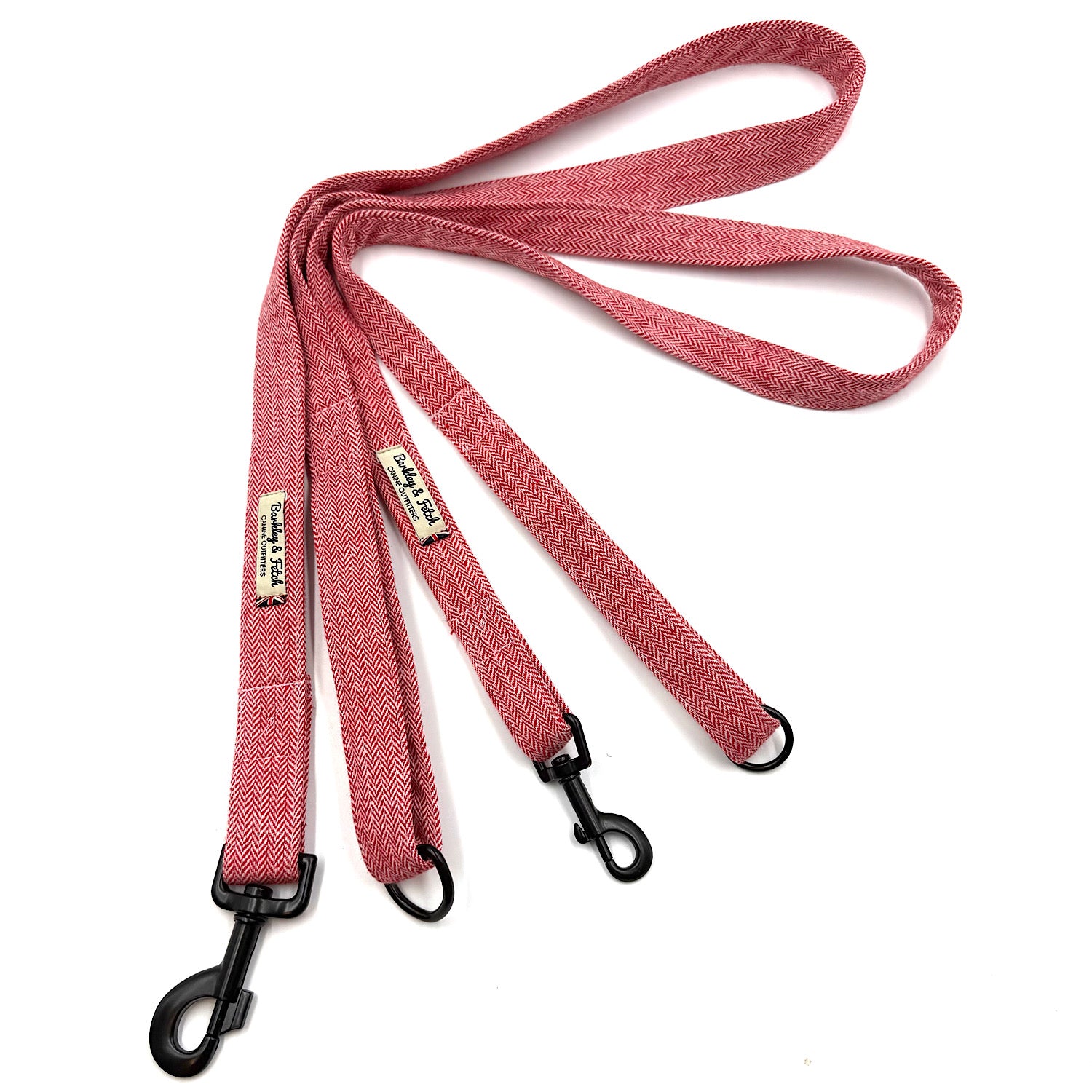 Red dog leash with black clips on a white background