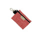 Red woven pouch with black strap and gold tag on a white background