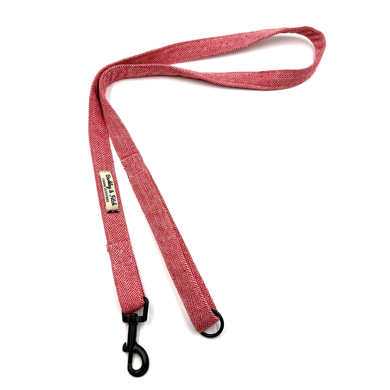 Red dog leash with black clip on a white background
