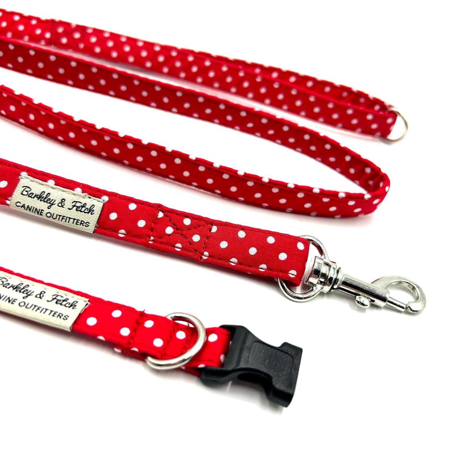 Red polka dot dog leashes with metal clasp on a white background
