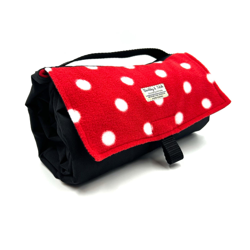 Red and black polka dot blanket with a brand label on a white background British handmade by Barkley and Fetch