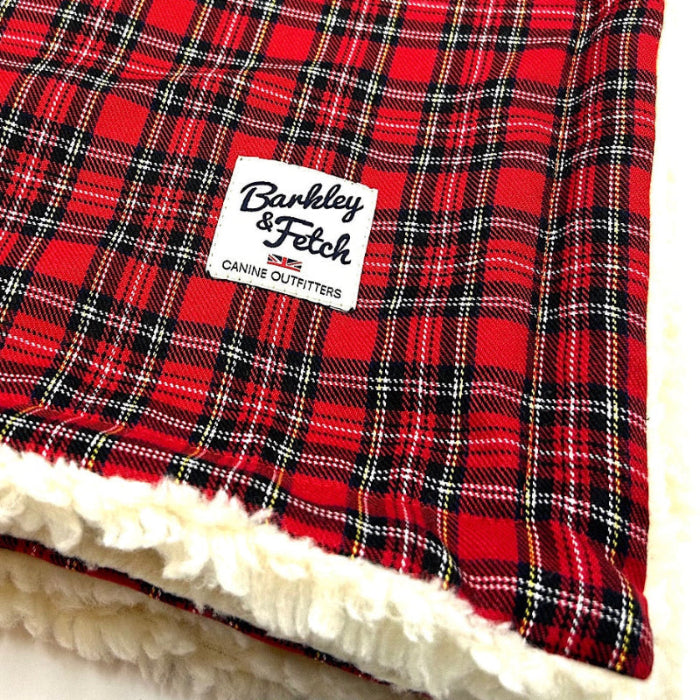 Red plaid blanket with a white label reading 'Barkley & Fetch' on a white background.