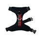 Black dog harness with red plaid pattern on a white background