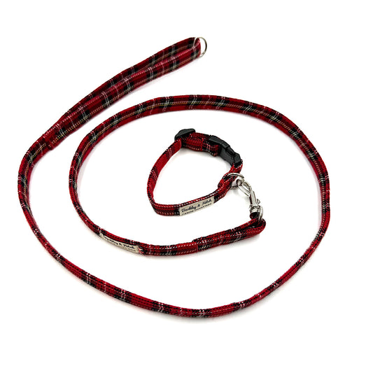 Red plaid dog leash and collar set on a white background