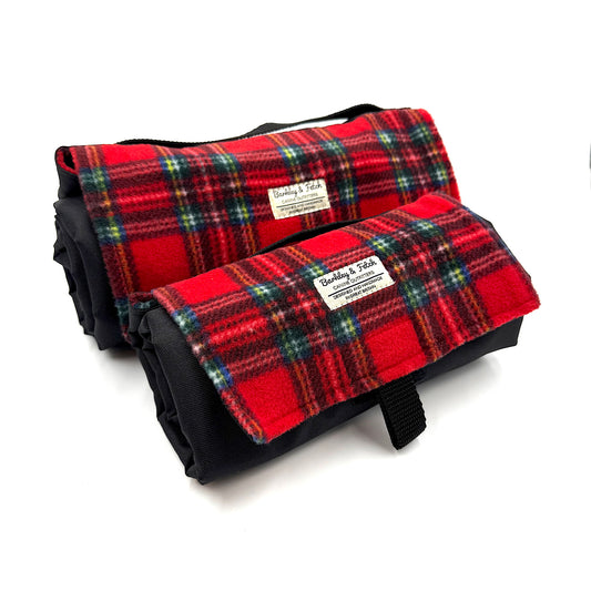 Two red plaid rolled up settle mats with black borders on a white background handmade in UK by Barkley And Fetch