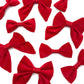 Multiple red bow ties arranged on a white background handmade by Barkley And Fetch